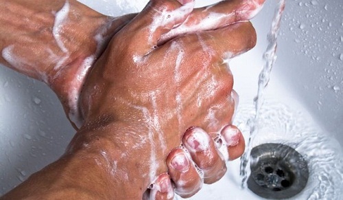 homme se lavant les mains avec du savon liquide