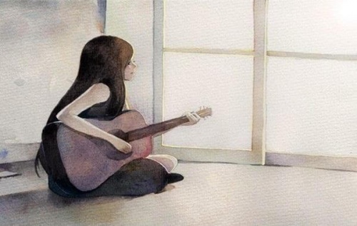 Femme-avec-une-guitare-assise-sur-le-sol