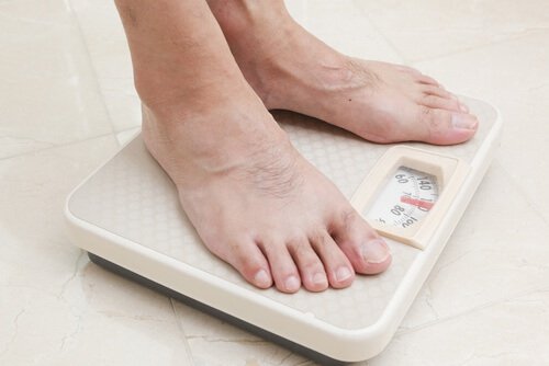 Les pieds d'un homme sur une balance
