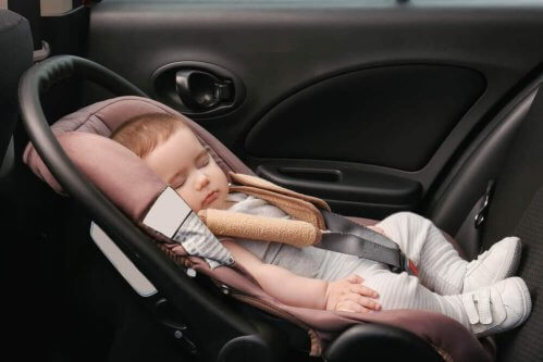 bébé qui dort dans le siège auto