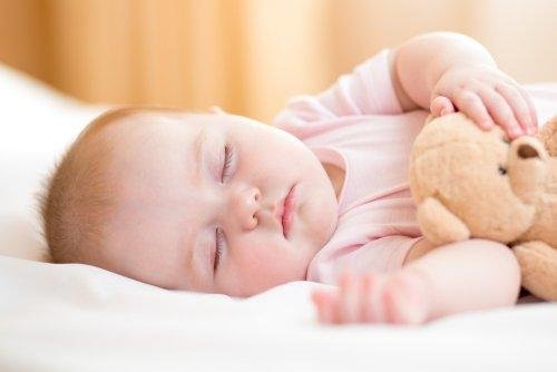 bébé qui dort sur le côté pour calmer les douleurs abdominales