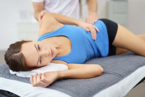 Une femme massée à la hanche car elle souffre d'une bursite trochantérienne