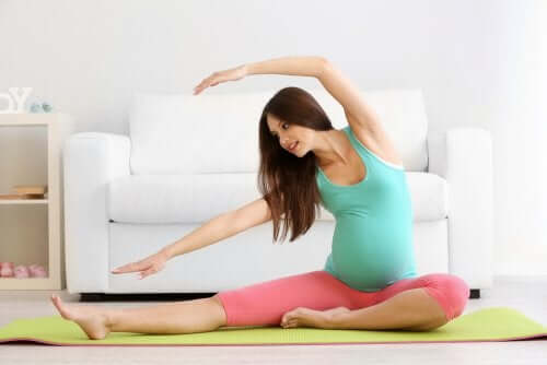 Une femme enceinte qui fait de l'exercice physique pour dissiper les douleurs osseuses