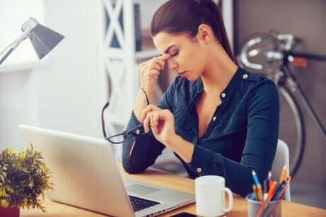 Une femme stressée devant son ordinateur. 