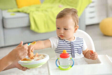 Un bébé mangeant avec une cuillère.