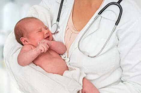 Un bébé dans les bras d'un pédiatre.