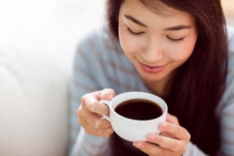 Une femme qui boit une boisson chaude.