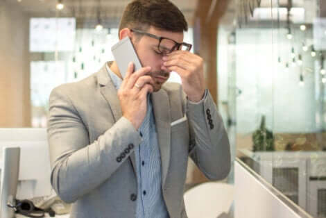 Un homme au bureau souffrant de fatigue visuelle.