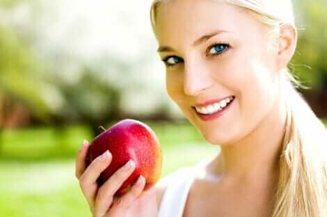 Une femme mangeant une pomme.